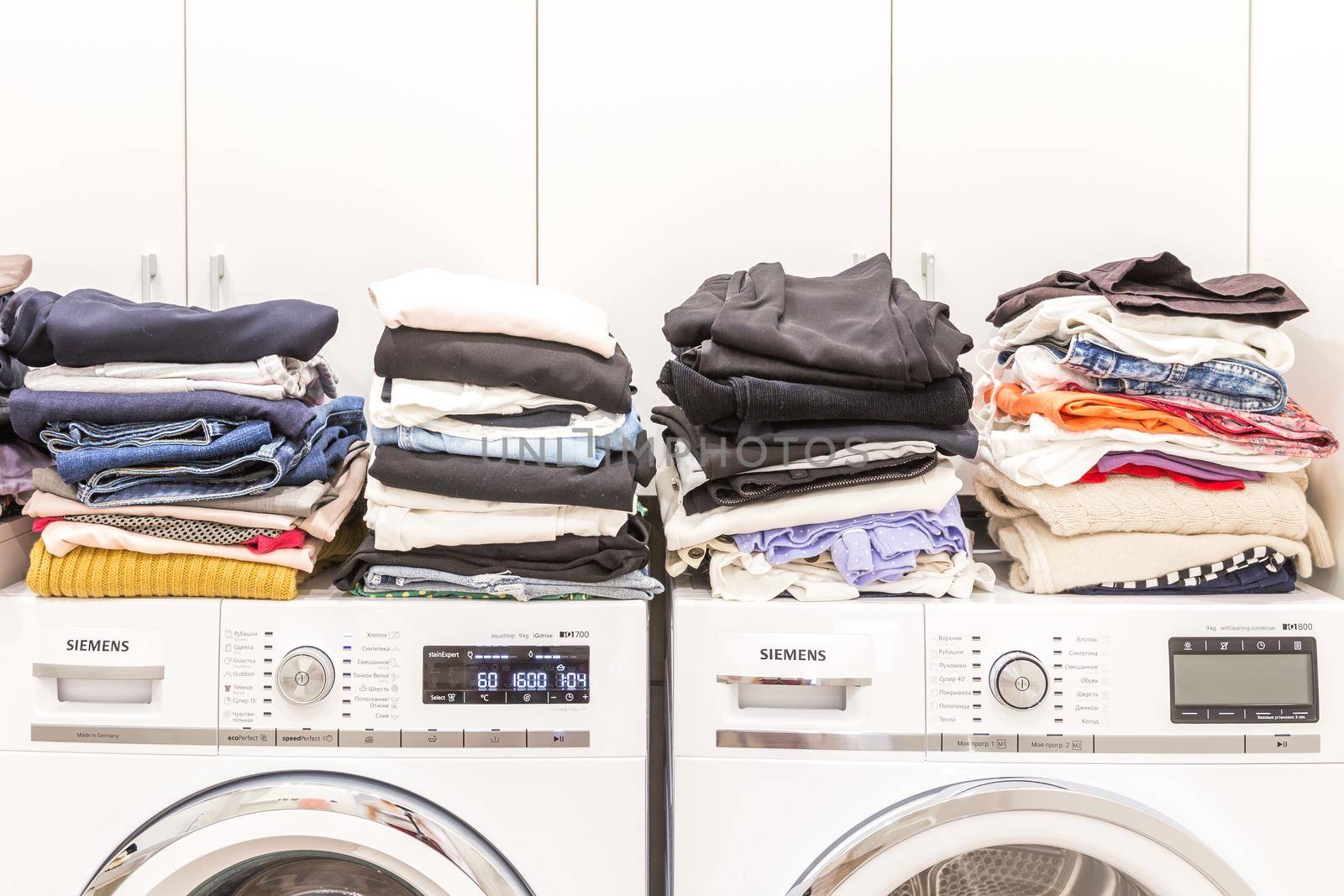 Piles of clean clothes in laundry room