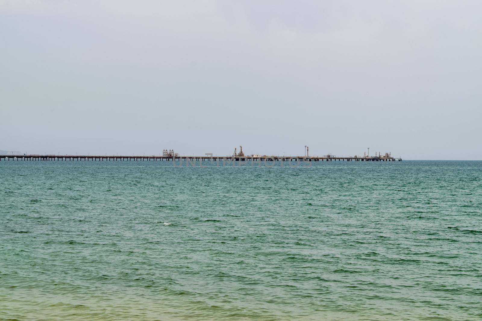 An oil pipeline and a dock for oil tankers. by silentstock639