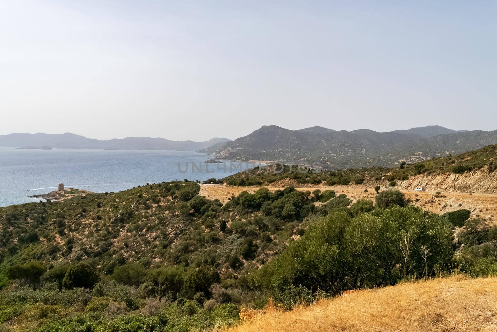 Beautiful view of the southern Sardinian sea. Note the historic Saracen tower on the rock formations.