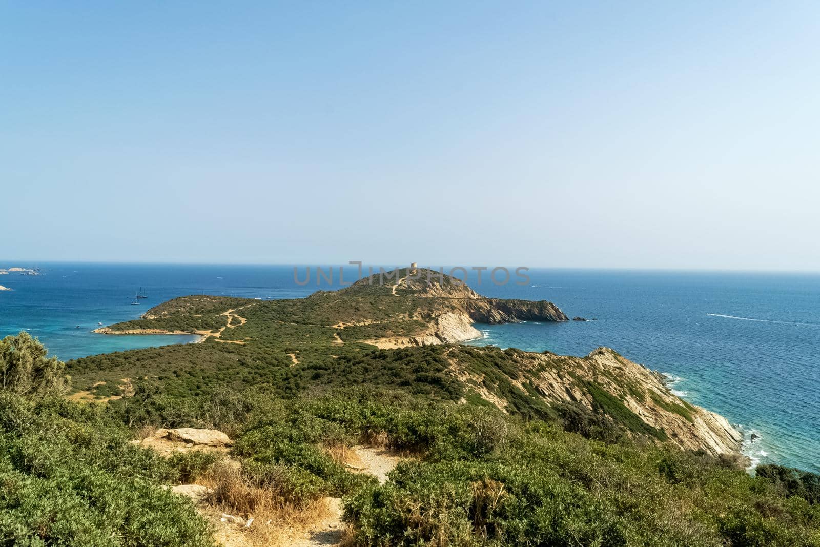 Beautiful view of the southern Sardinian sea. Note the historic Saracen tower on the rock formations.