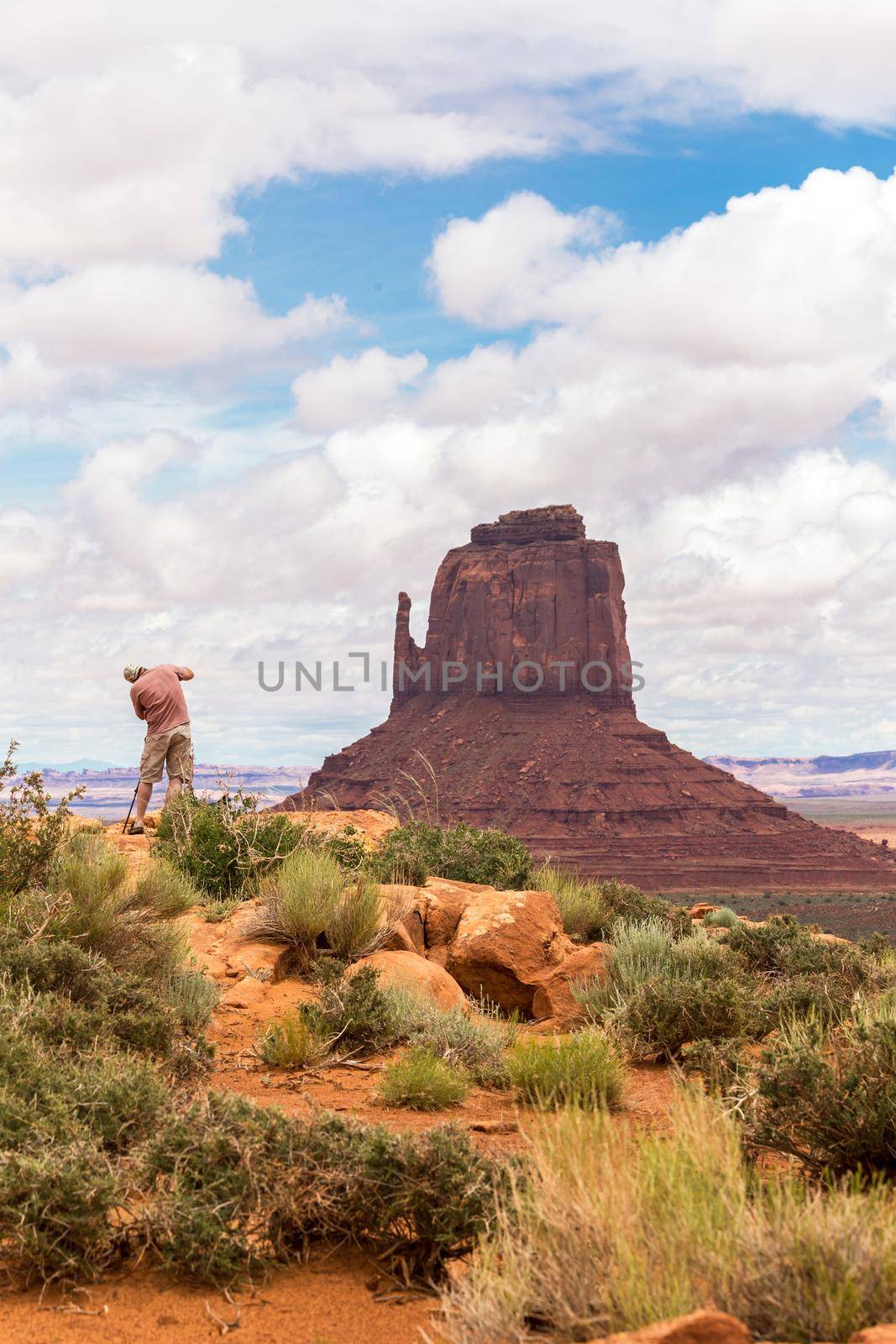 Hiker photographer taking picture of the Monument Valley from view point