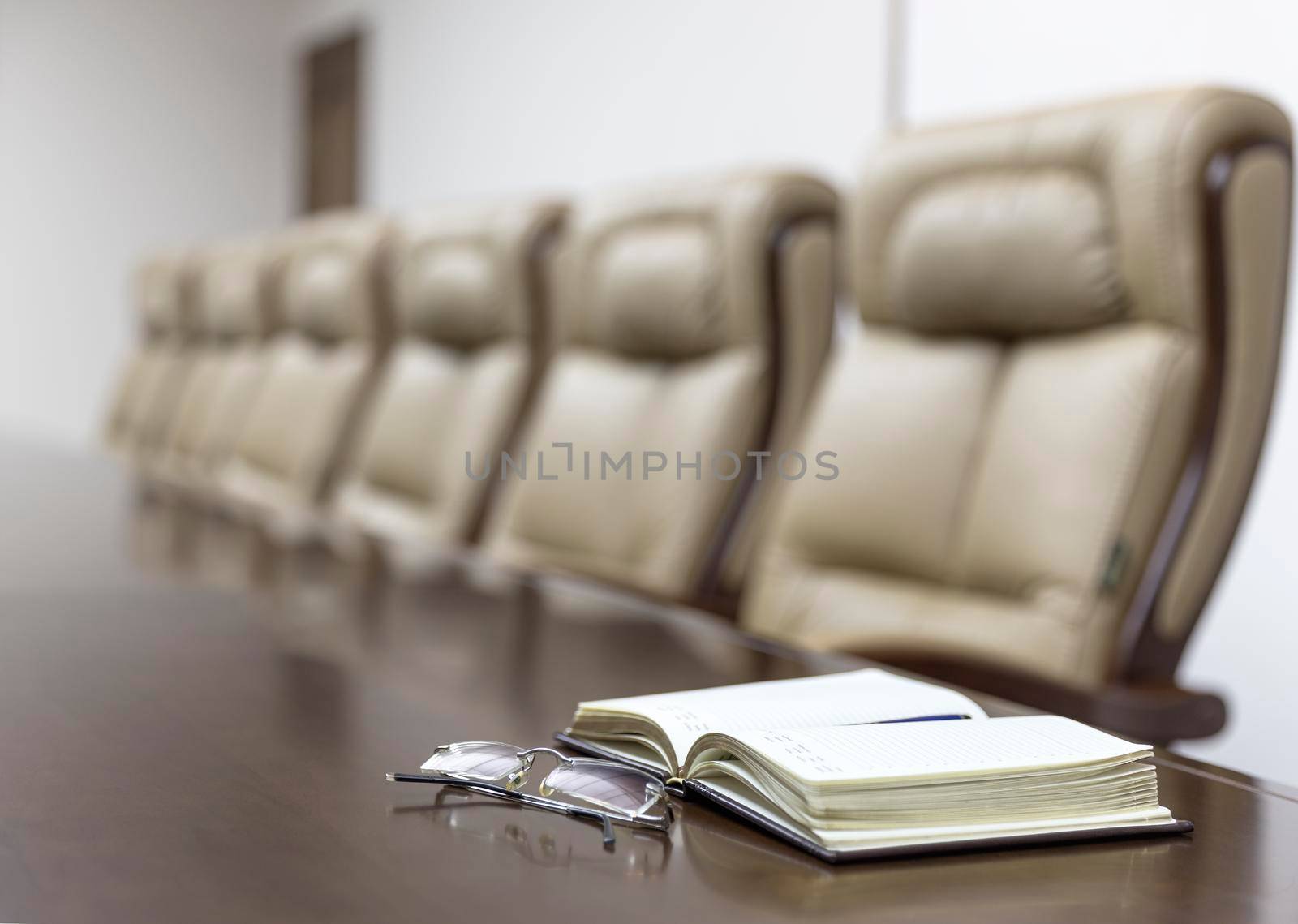 Closeup of on table in empty corporate conference room before business meeting in office