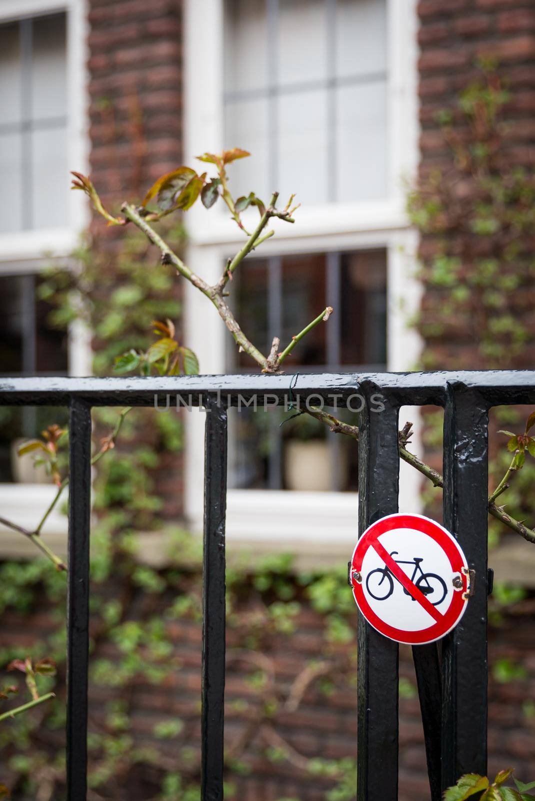 Sign of no bikes on a fence near house