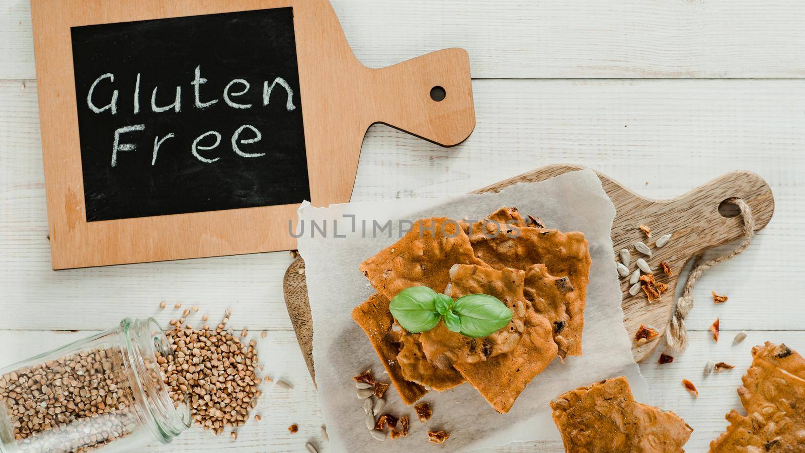 Gluten-freen crispbreads made of buskwheat flour. Green buckwheat flour smoked paprika sunflower seeds ingredients homemade baked crisp bread. Idea recipe snacks gluten free concept. Top view flat lay