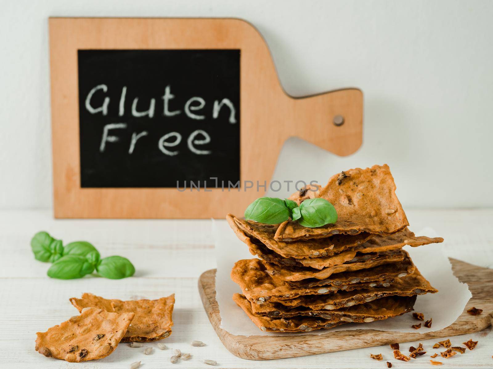 Gluten-freen crispbreads made from buskwheat flour. Green buckwheat flour, smoked paprika, sunflower seeds is ingredients for this homemade baked crisp bread. Idea recipe snacks, gluten-free concept