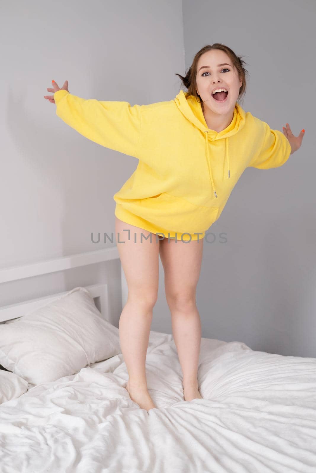 charming sweet young woman in yellow hoodie.