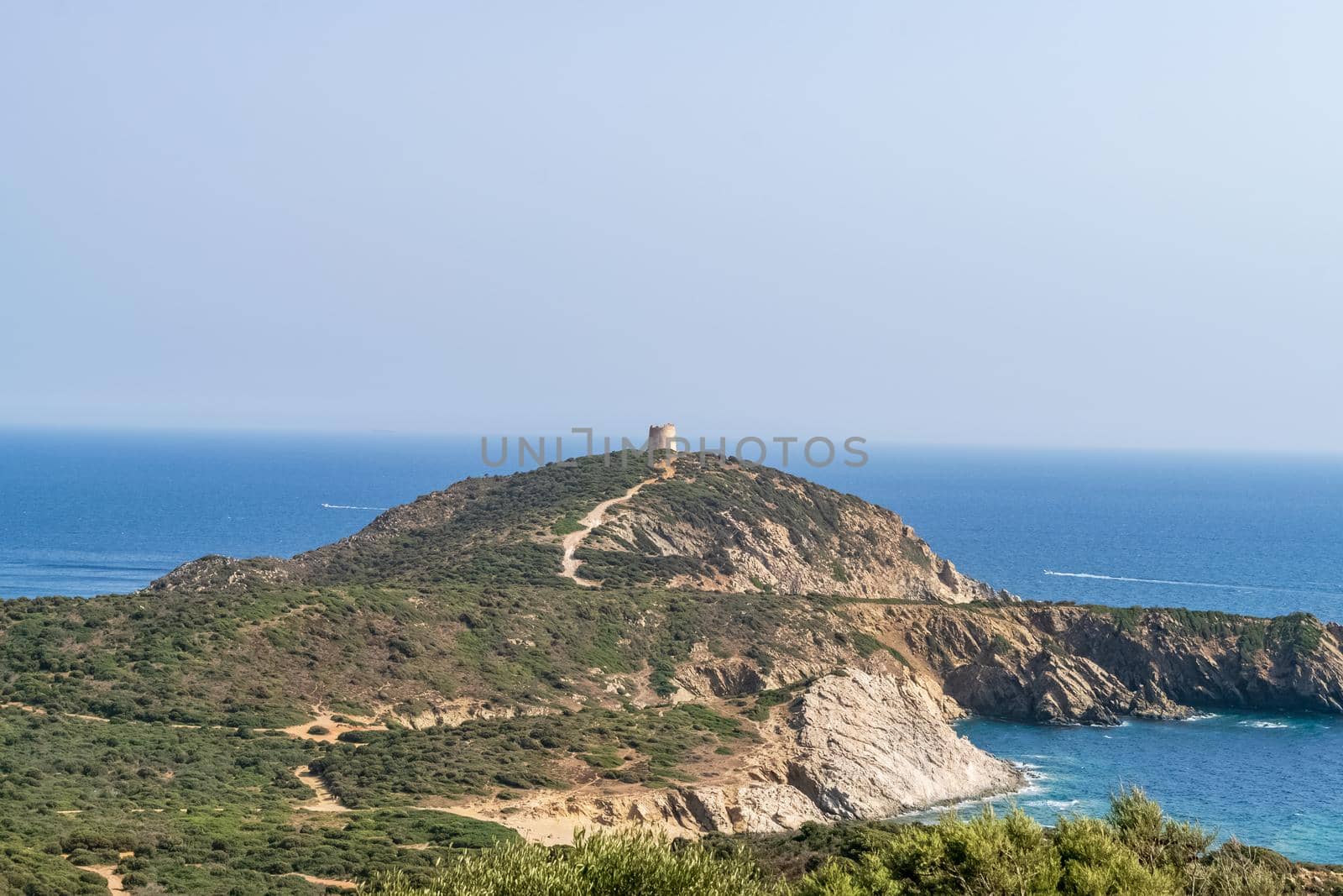 Beautiful view of the southern Sardinian sea. Note the historic Saracen tower on the rock formations.