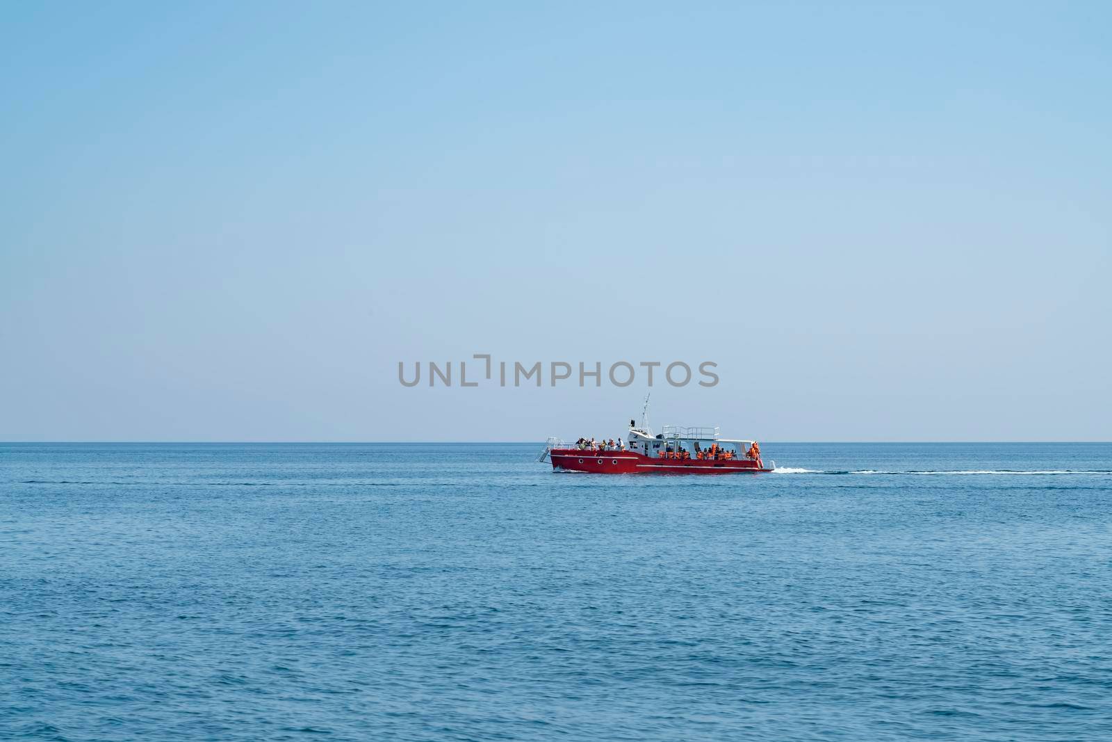 a pleasure boat moves along the sea horizon. High quality photo