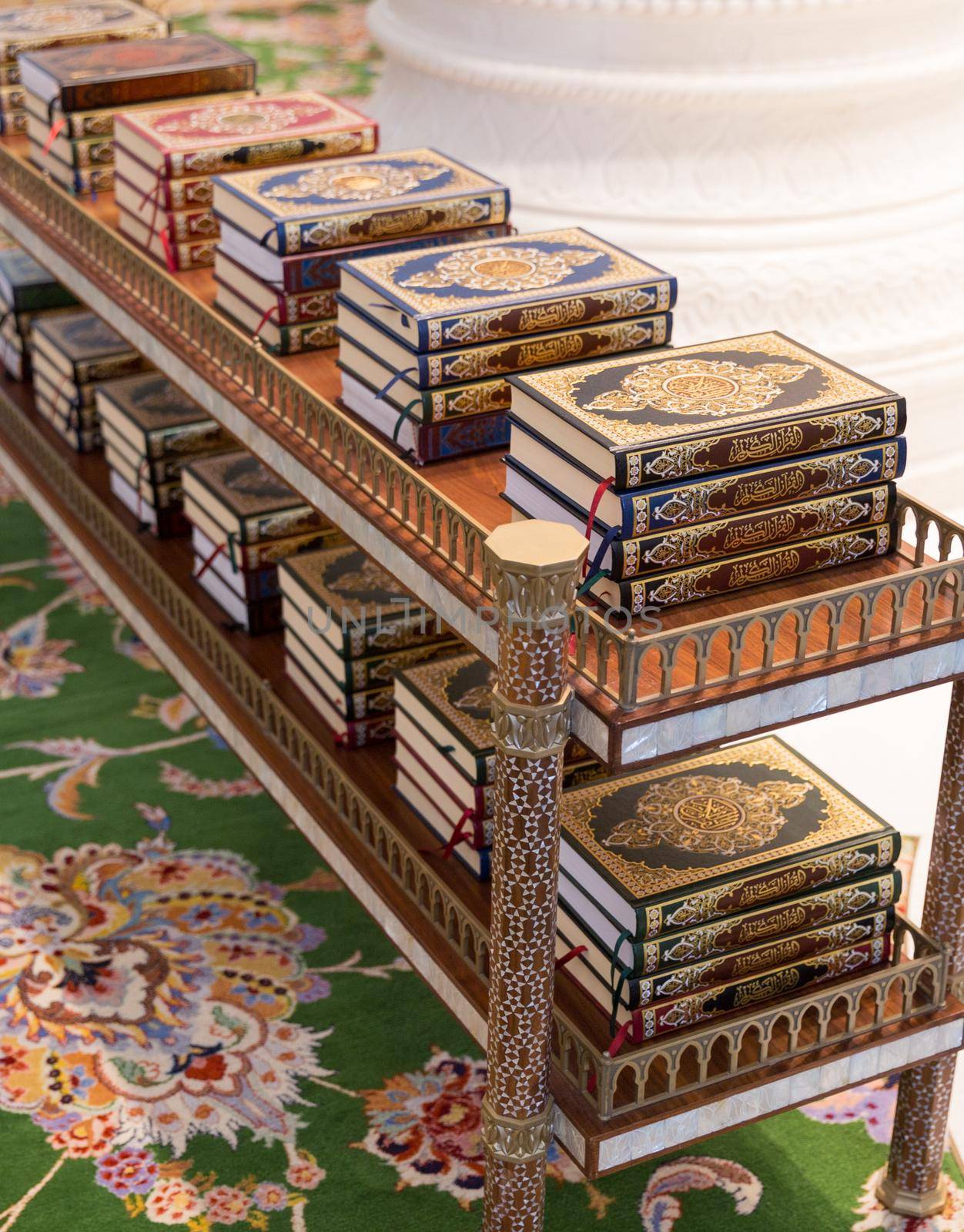 holy Quran books on a shelf in a mosque