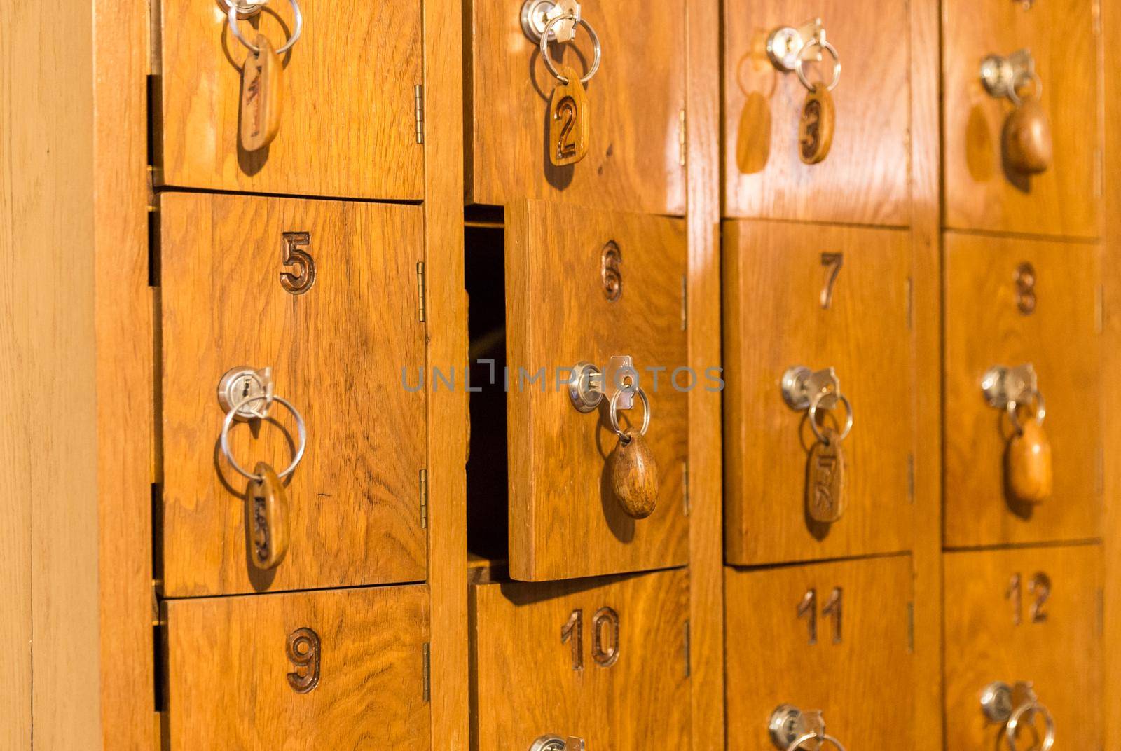 Wooden cells with keys for storing cell phones in Italian restaurant while eating