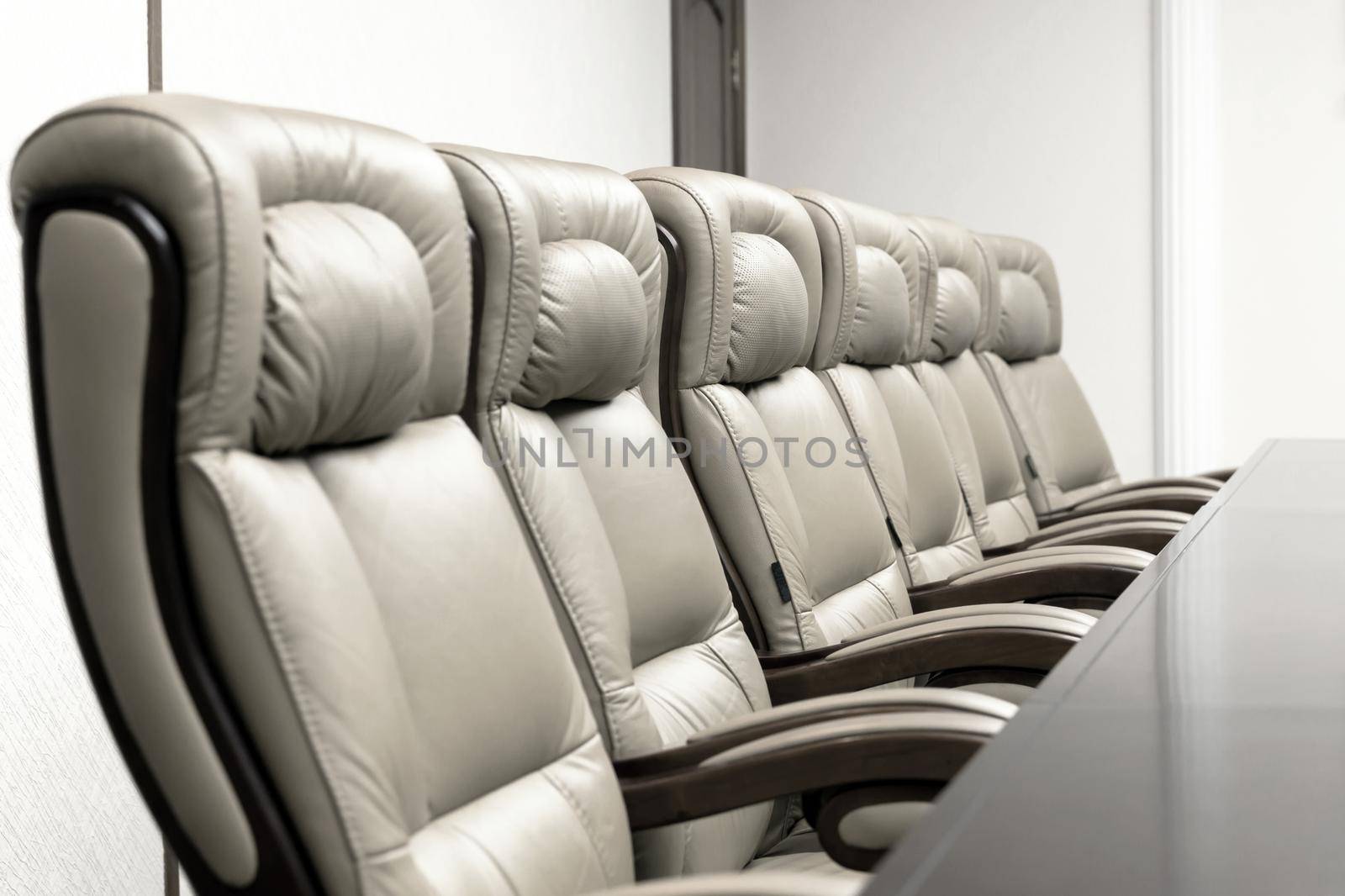 conference room with wooden table and beige leather armchairs