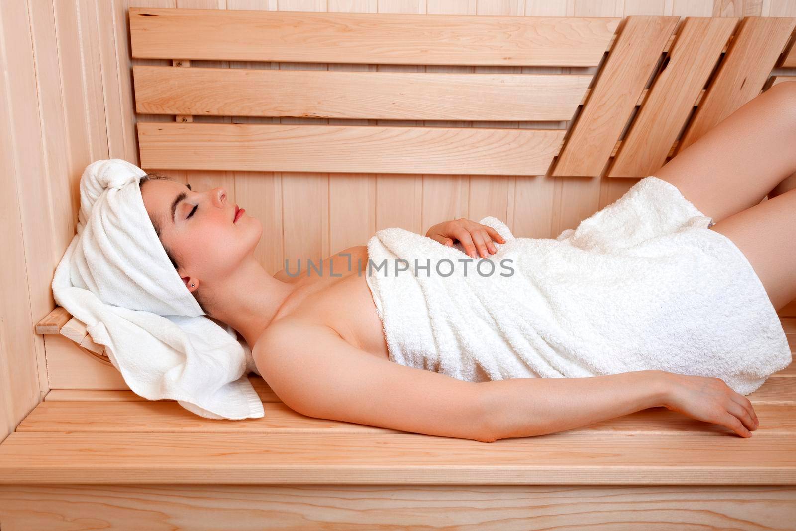 Pretty woman relaxing in a sauna by Nobilior