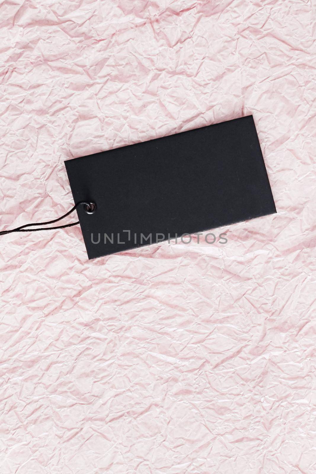 Black horizontal price tag on pink paper background by Anneleven