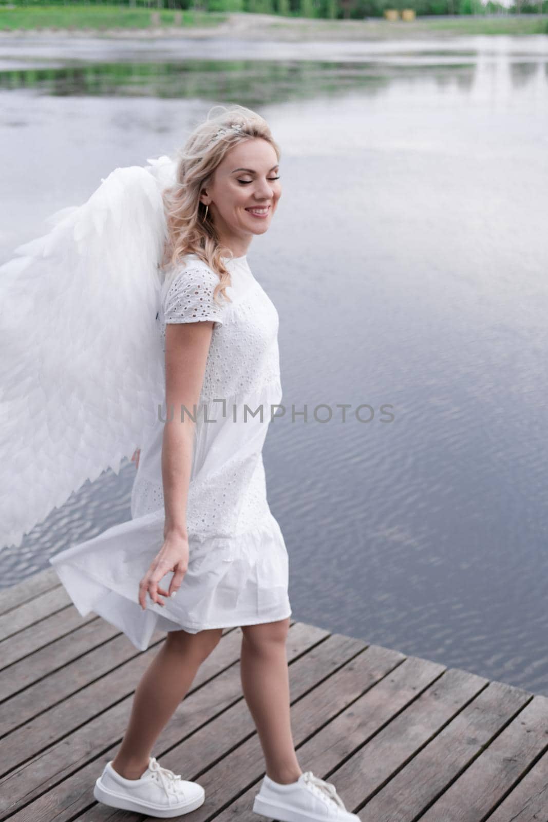 portrait of blonde woman in white dress and white angels wings. good people. heaven, god. paradise angel by oliavesna