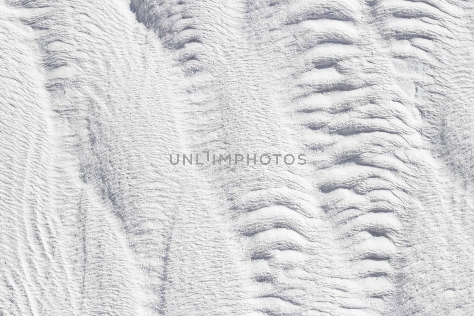 Abstract gray and white texture of Pamukkale calcium travertine in Turkey, vertical pattern, close-up.