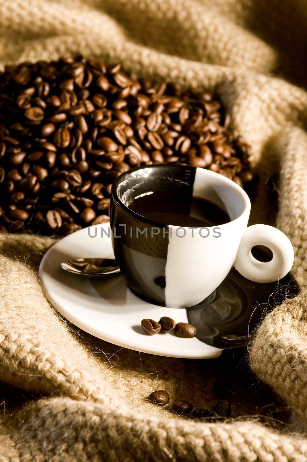 coffee cup and coffee beans on canvas