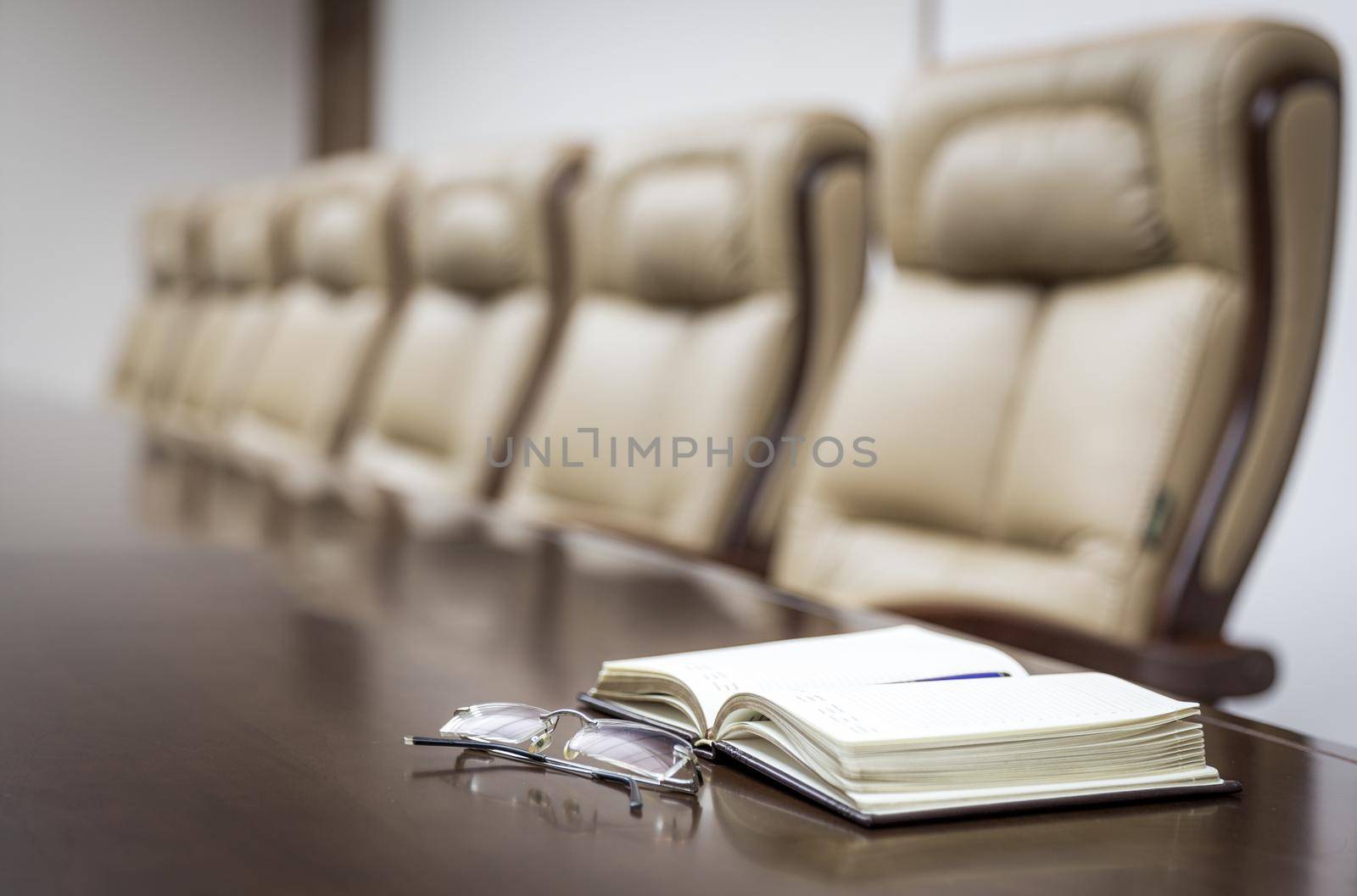 Closeup of on table in empty corporate conference room before business meeting in office