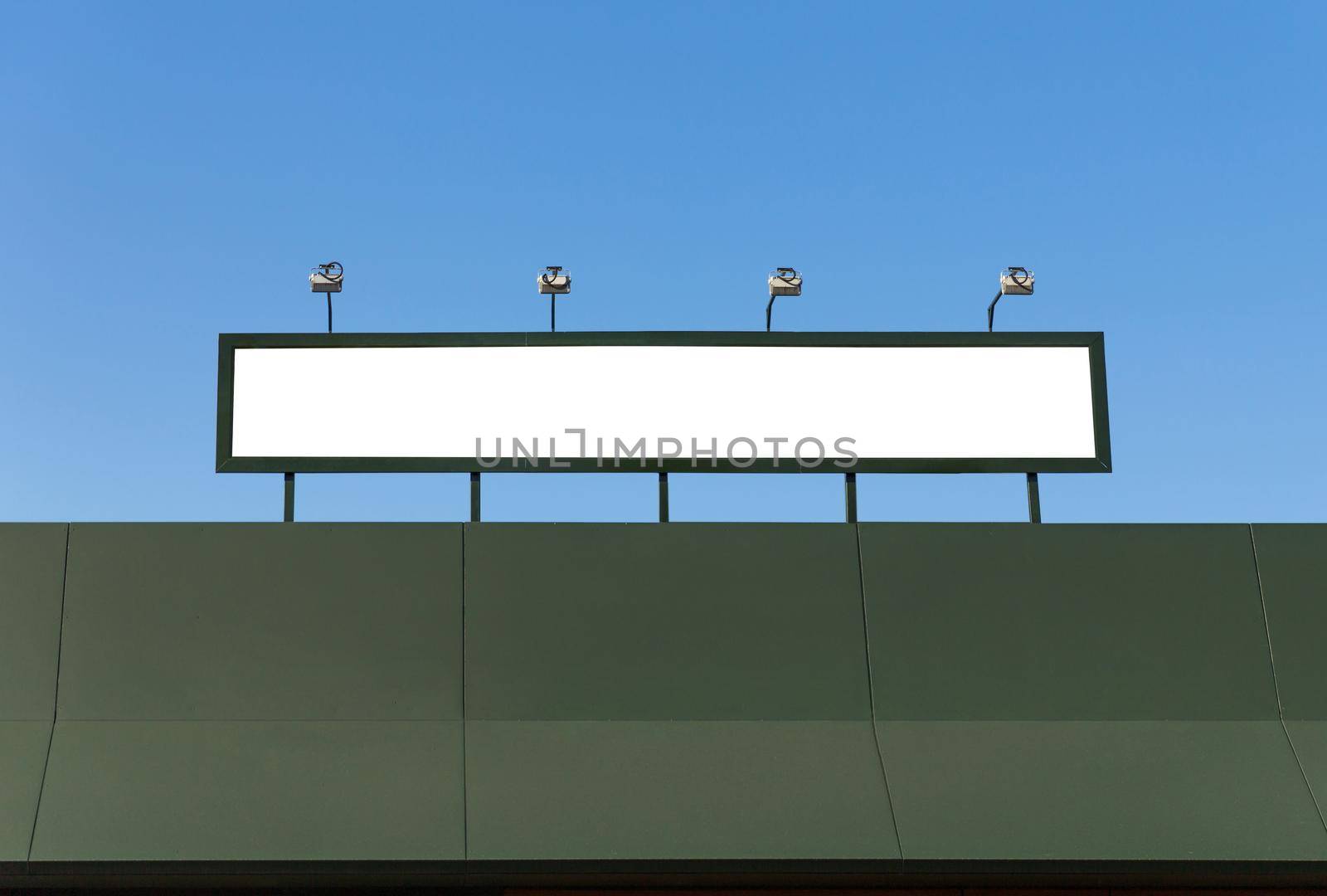 Blank sign with lights on the roof of a building