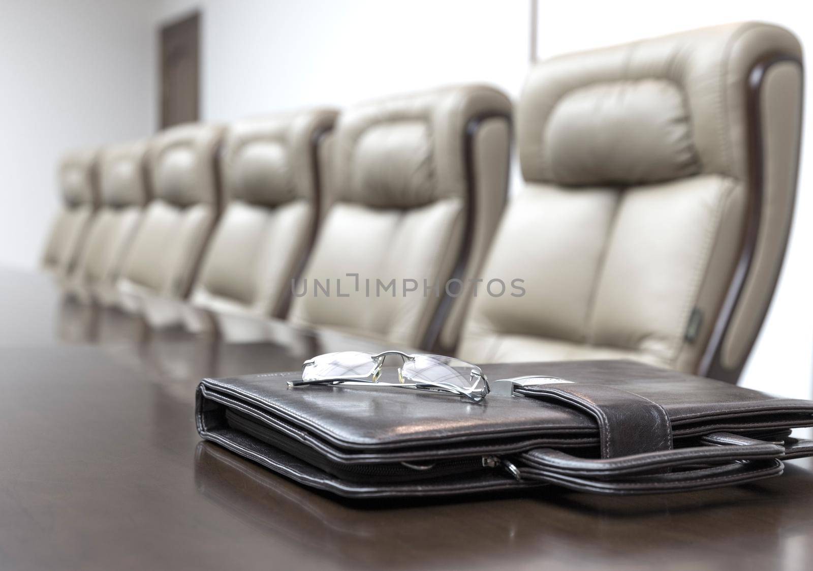 Closeup of on table in empty corporate conference room before business meeting in office