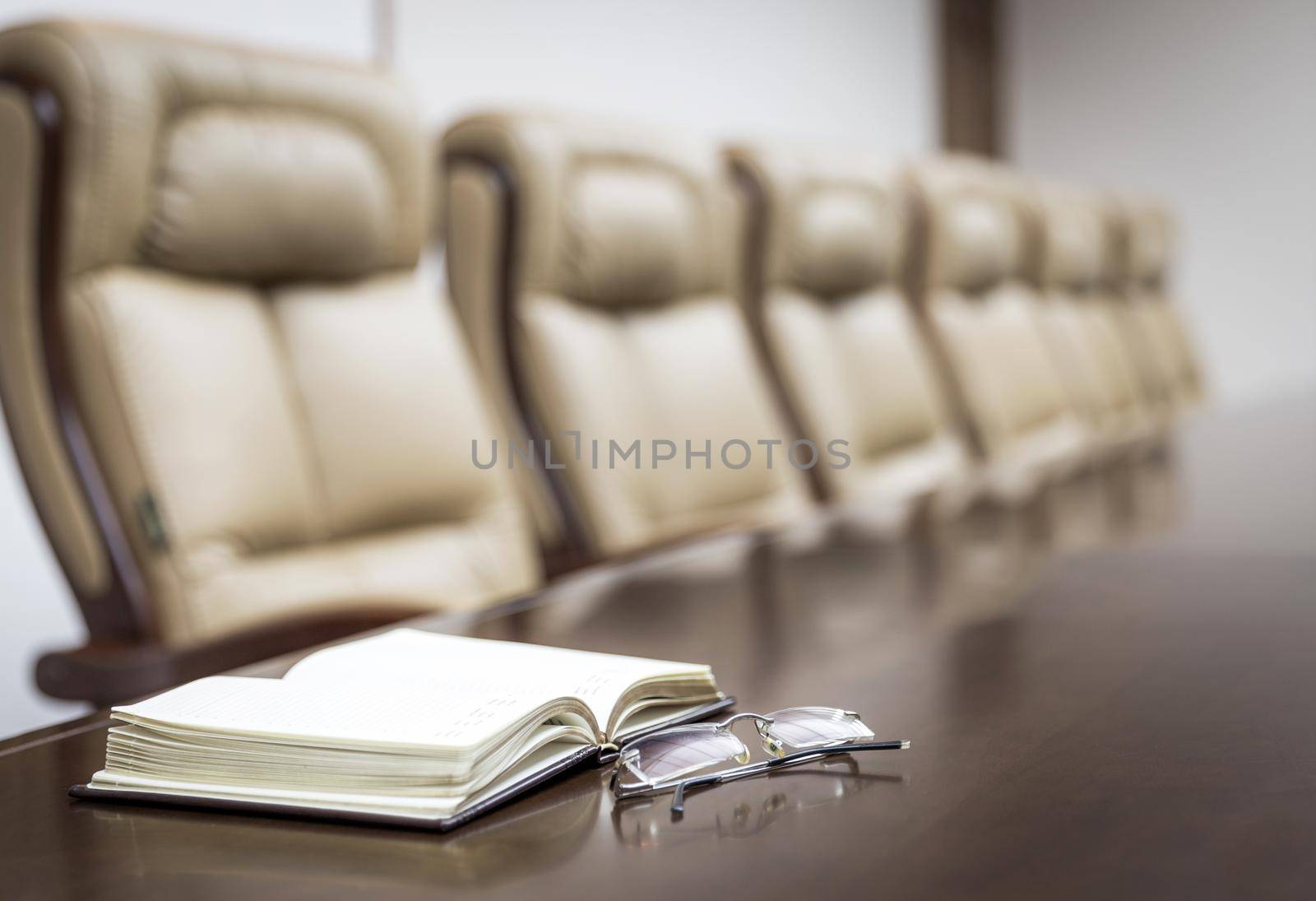 Closeup of on table in empty corporate conference room before business meeting in office