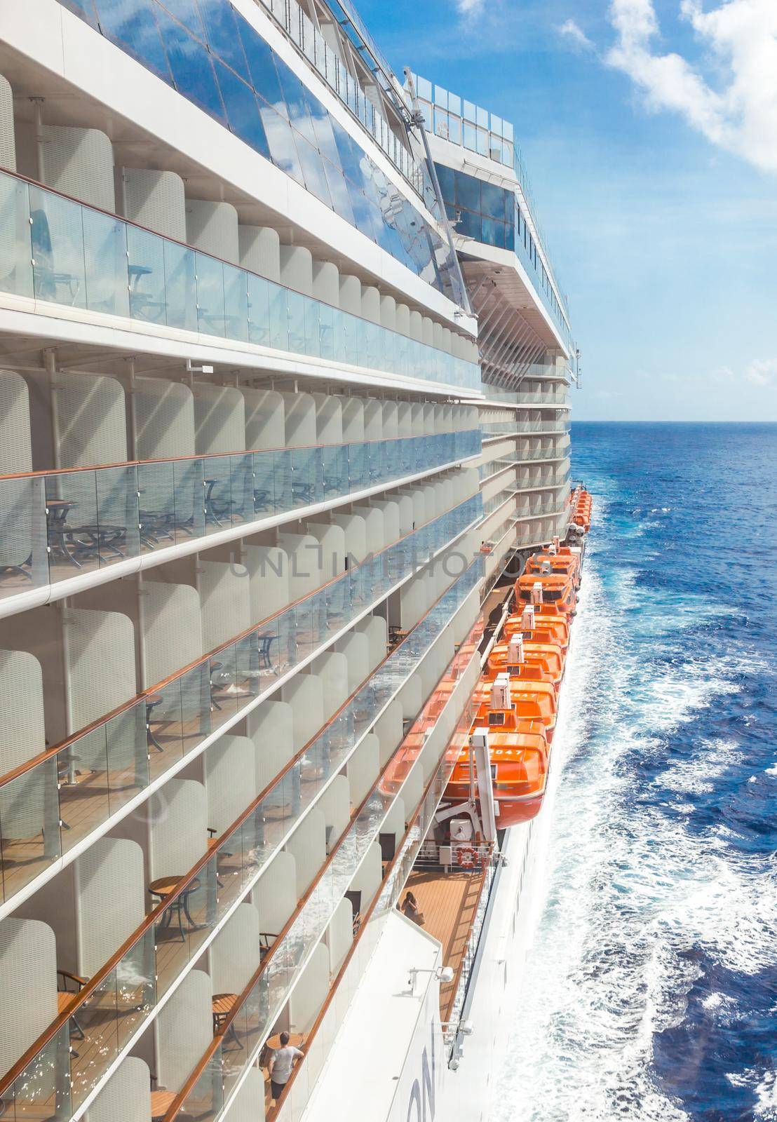 Ocean view from a cruise ship deck on a bright day with blue skies and clouds in the Pacific ocean