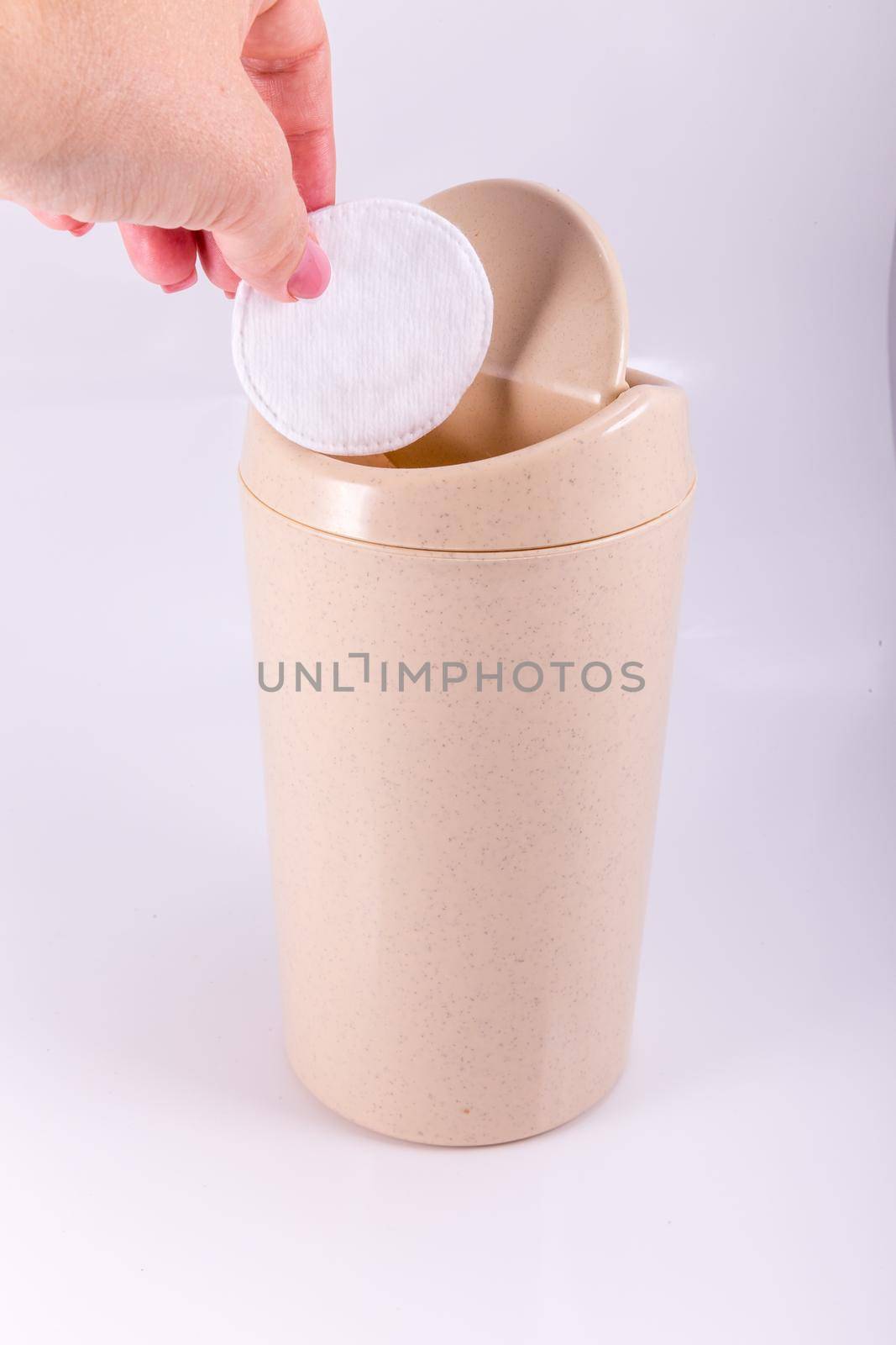 Plastic beige trash bin isolated on white background