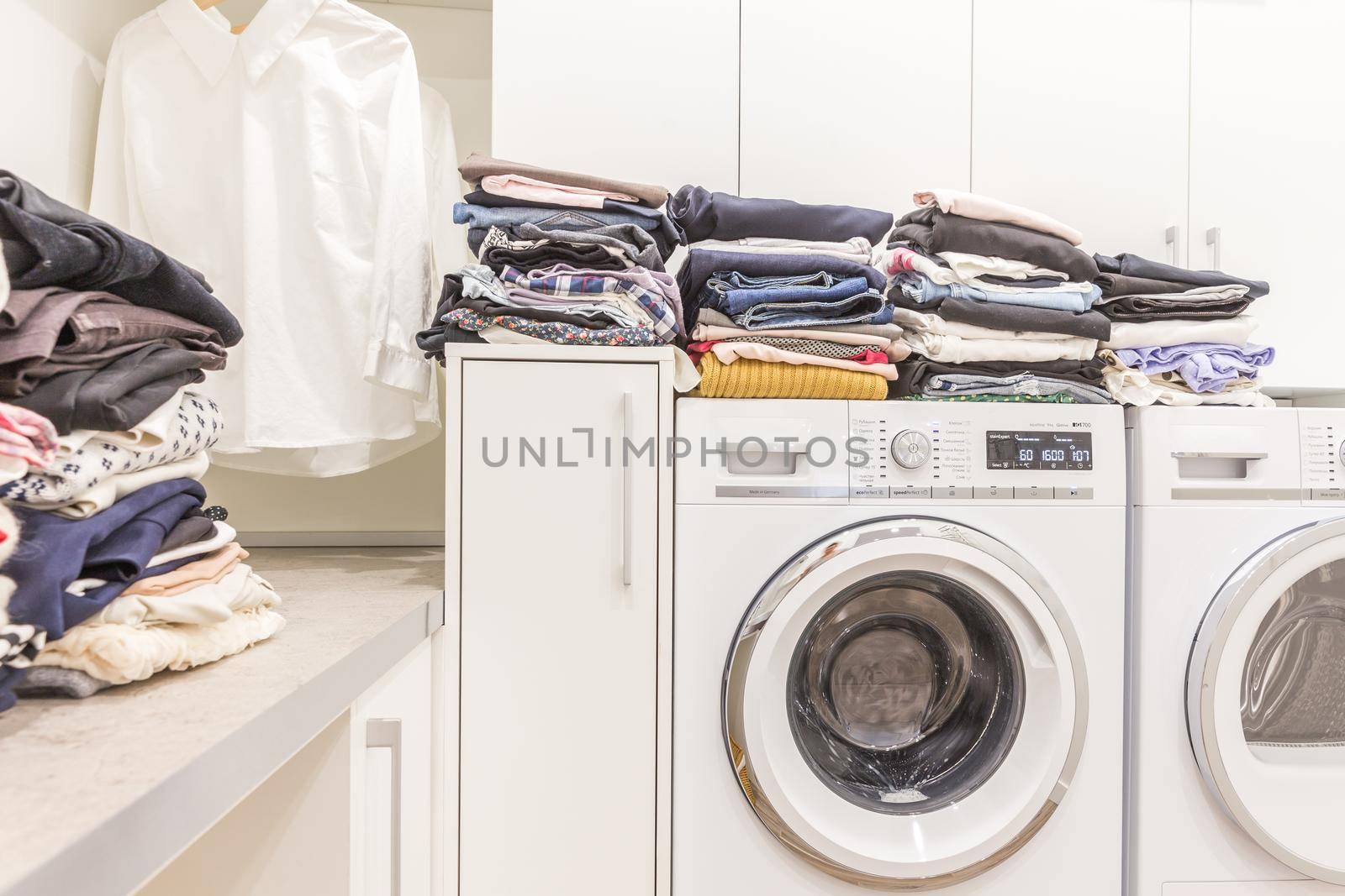 Piles of clean clothes in laundry room