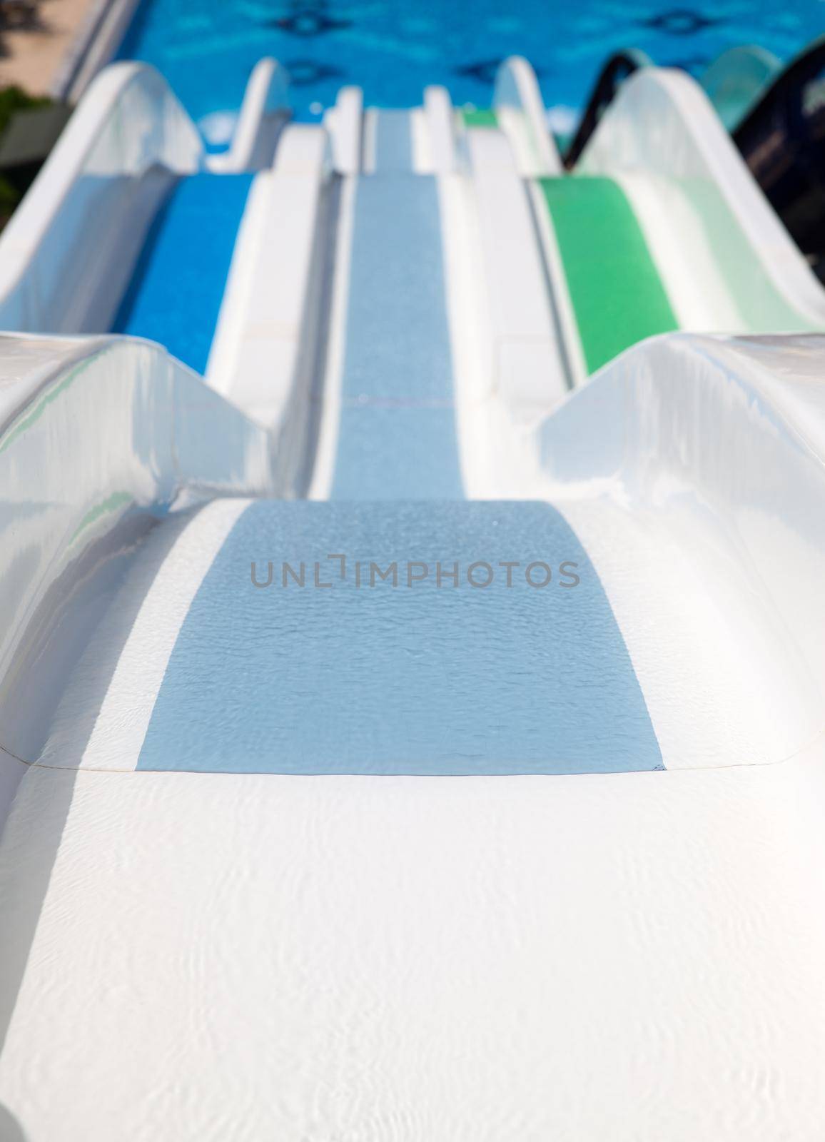 Colorful waterpark tubes and a swimming pool. Outdoor shot