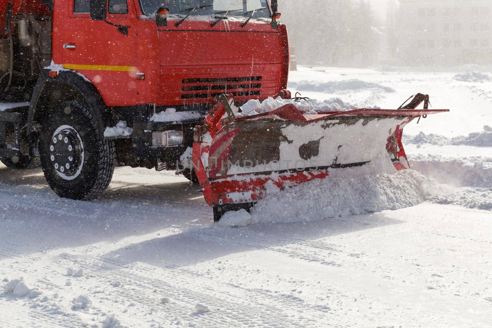 Snowplow removing snow from city road