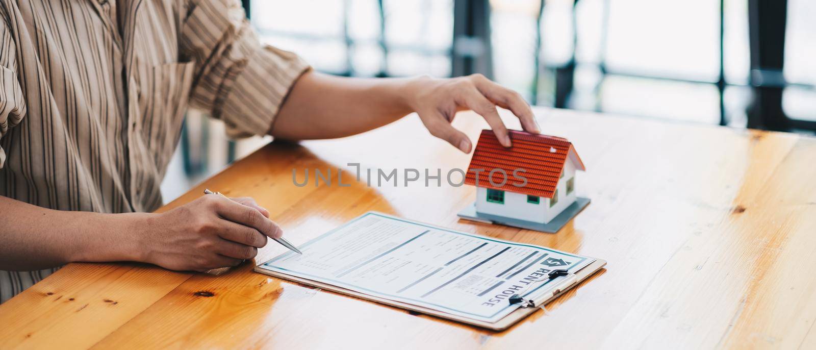 Real estate agent offer hand for customer sign agreement contract signature for buy or sell house. Real estate concept contact agreement concept by nateemee