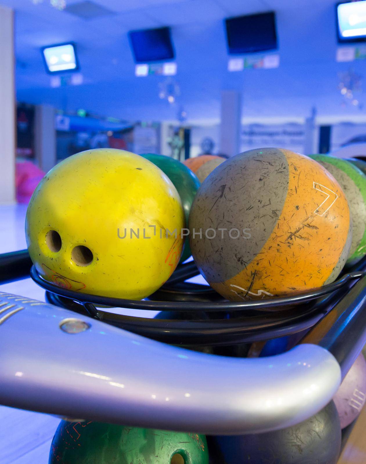 a set of multi coloured balls for bowling playing