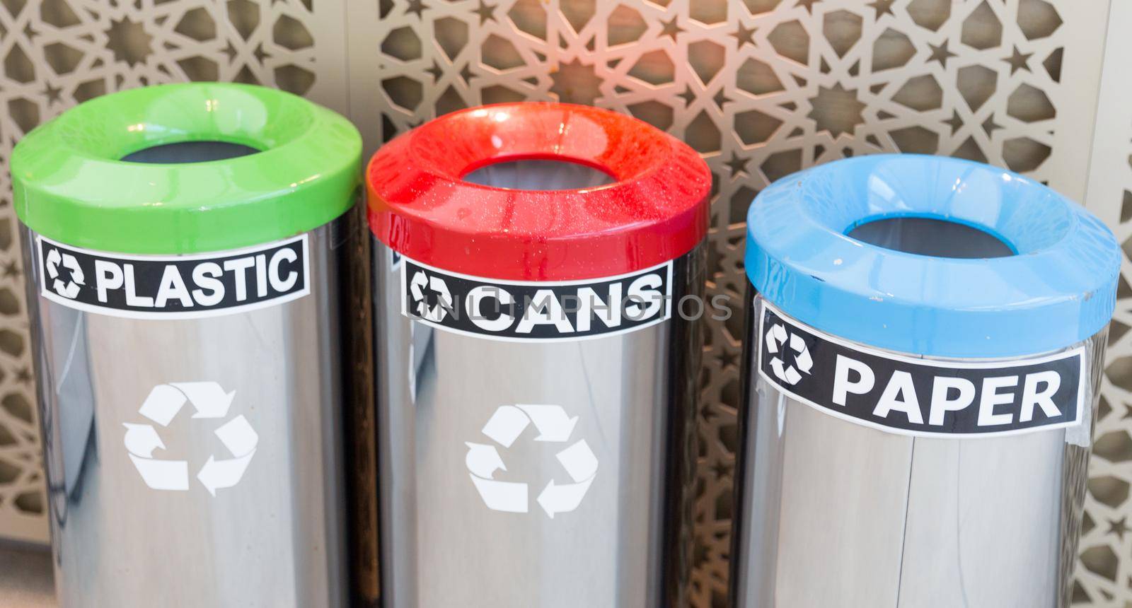 three bins for garbage seperation, plastic, cans, paper