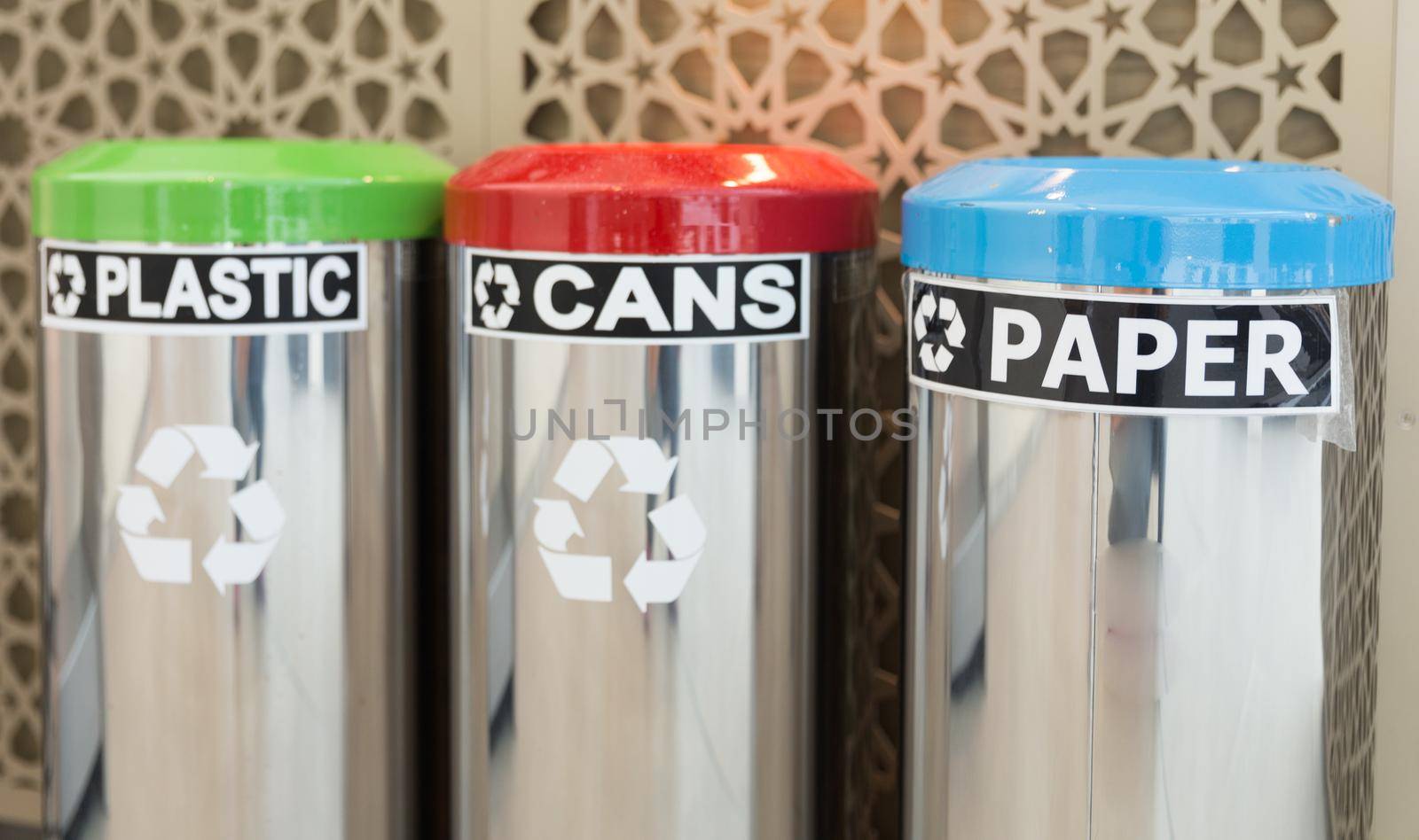 three bins for garbage seperation, plastic, cans, paper