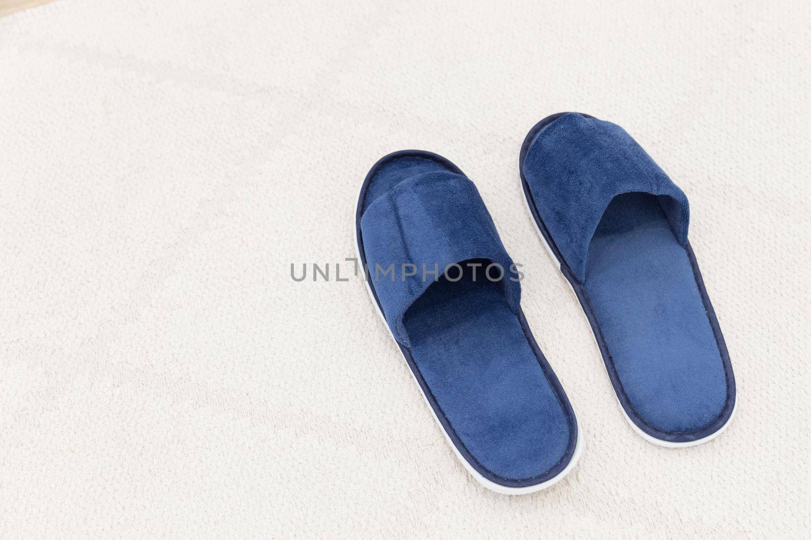 Blue man hotel slippers with copy space