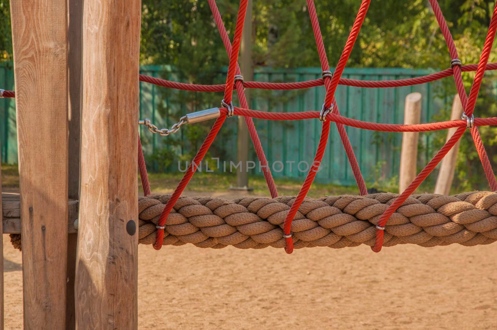 Empty old wood playground in summer day with rope