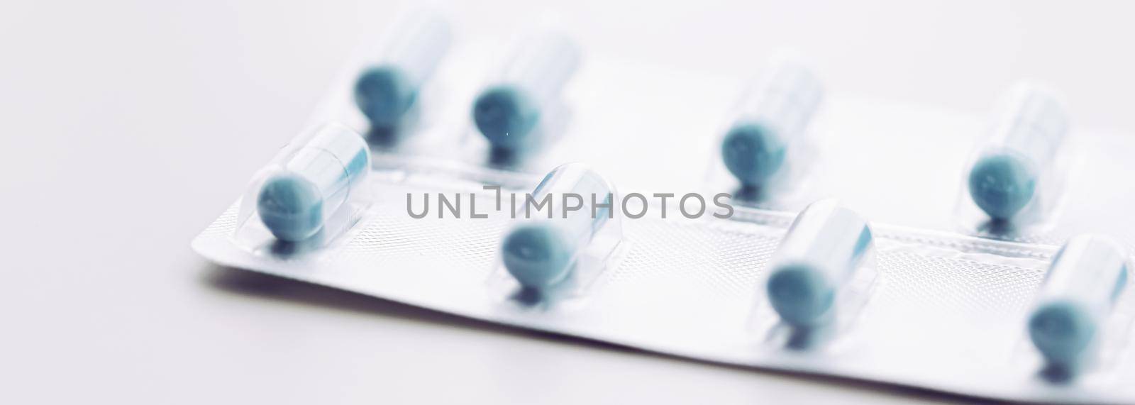 Blue pills and capsules as nutrition supplement, wellness and health care concept