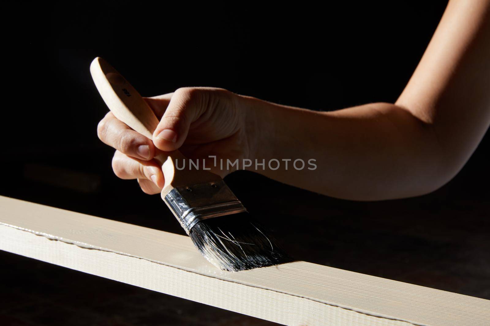 Hand painting surface of natural wood plank into white color