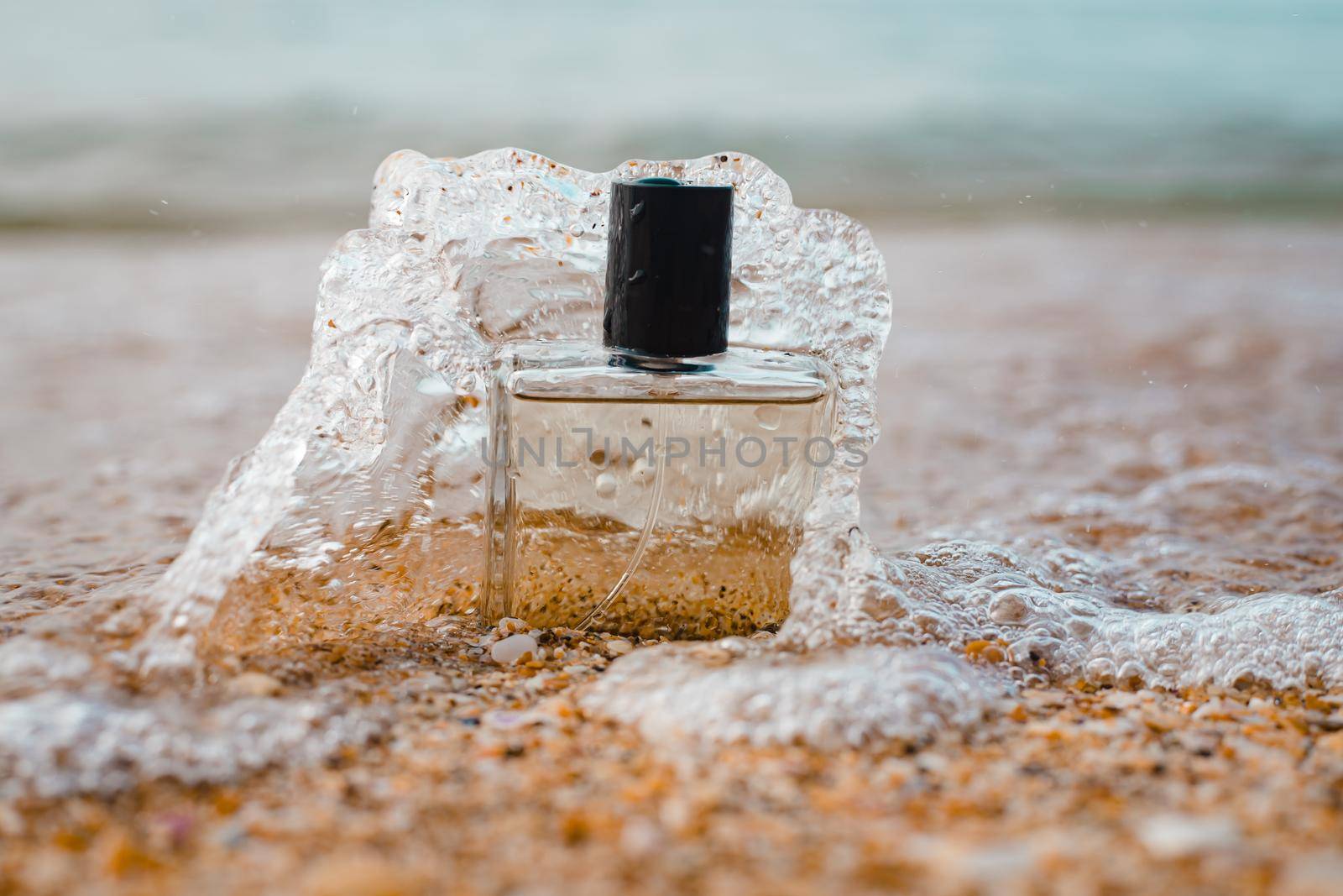 A bottle of perfume on the background of the sea . Men's perfume. Smell. Copy Space