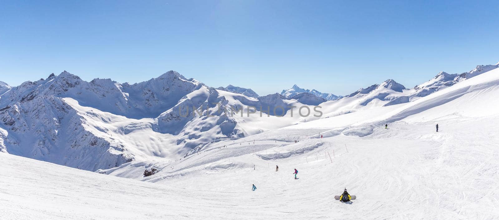 White snowy winter Caucasus mountains at sunny day. Panorama view from ski slope Elbrus, Russia with sky background