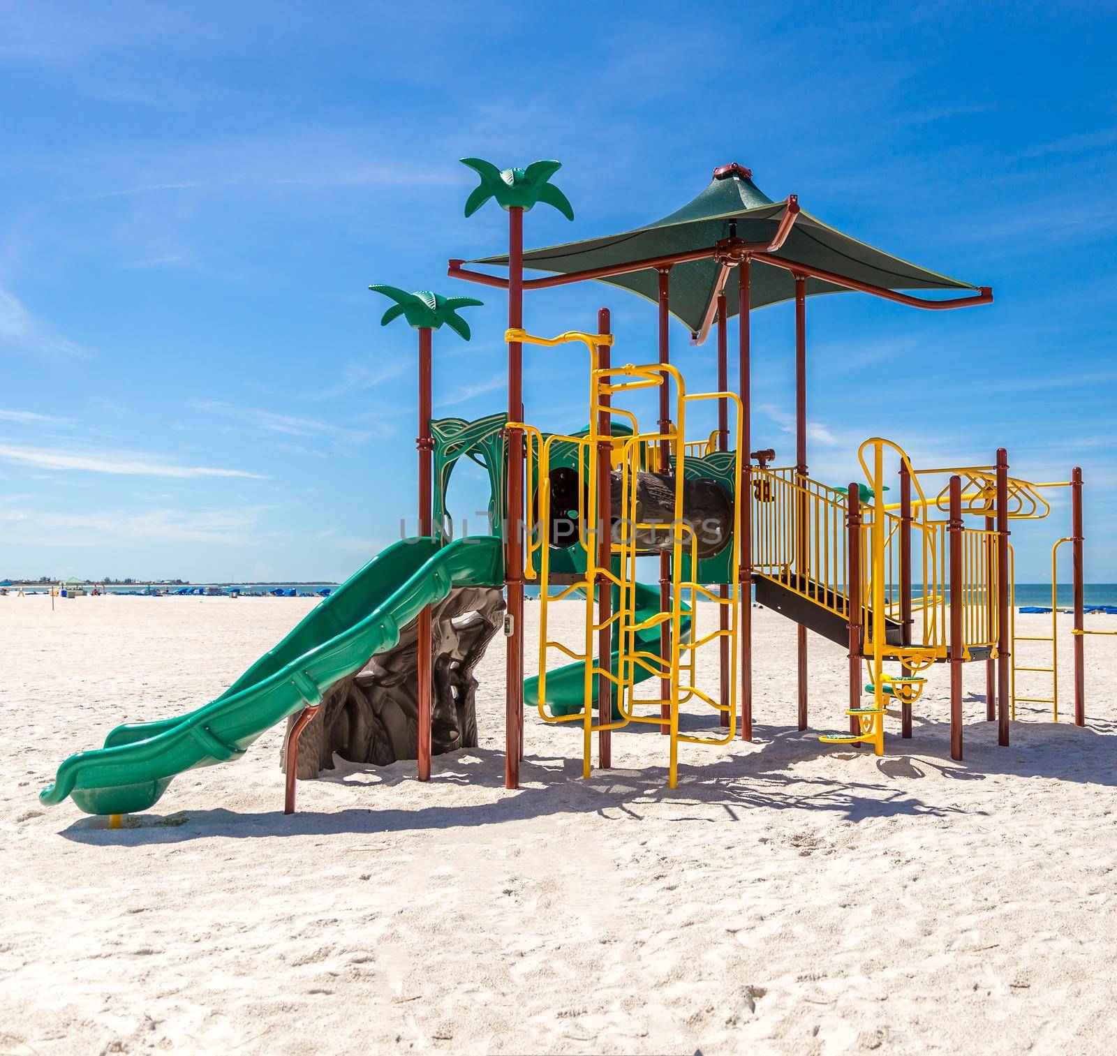 Children playground on the sunny beach with blue sky