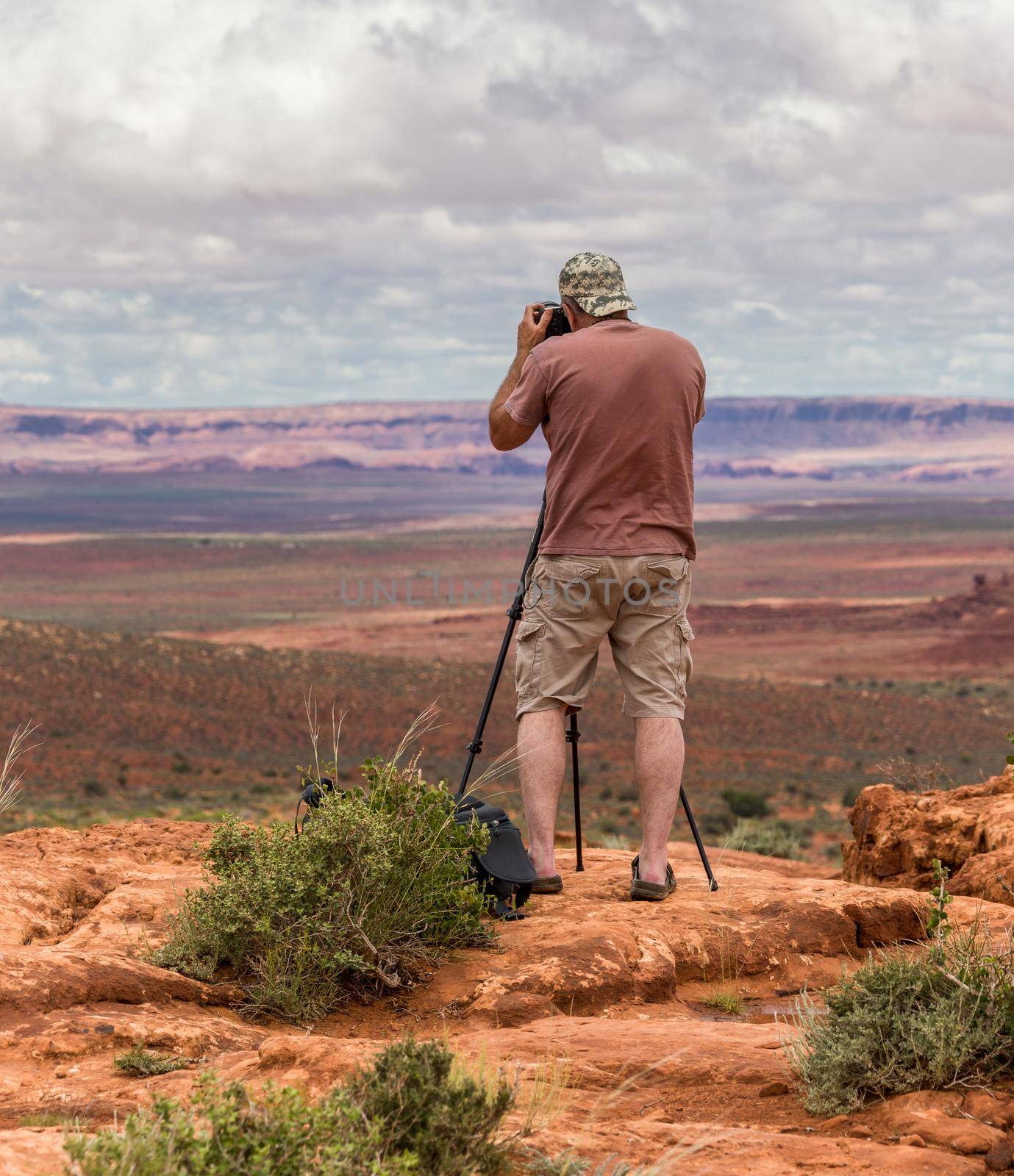 Hiker photographer taking picture of the Monument Valley from view point