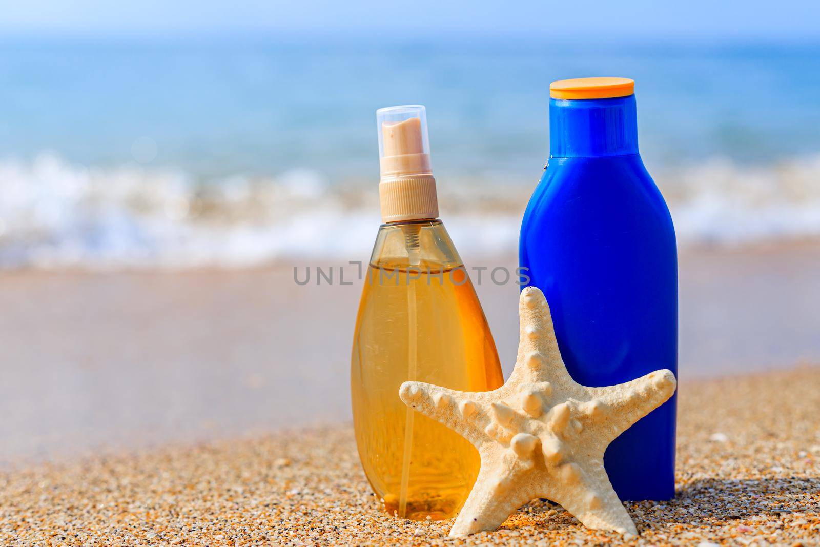 Sunburn milk on the background of the sea .Protection of the skin from the sun. Uniform tan. sfp . Beach holidays. Vacation at the sea . Sea wave