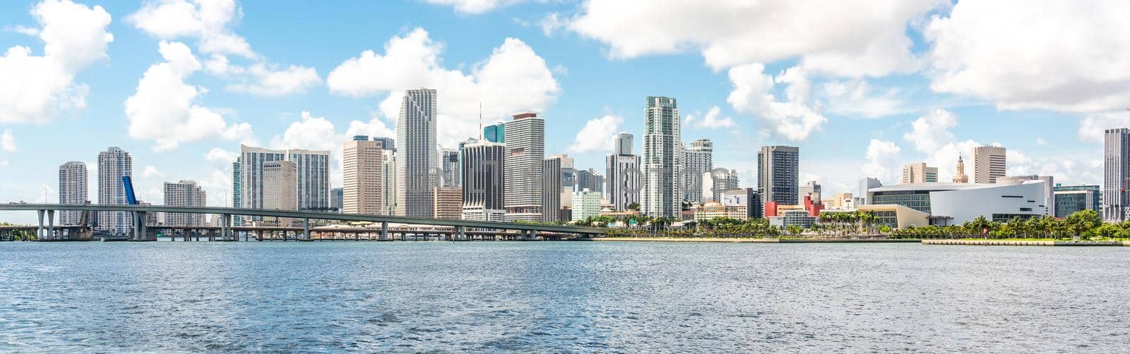 Miami, USA - September 11, 2019: Miami skyline with skyscrapers and bridge over sea by Mariakray