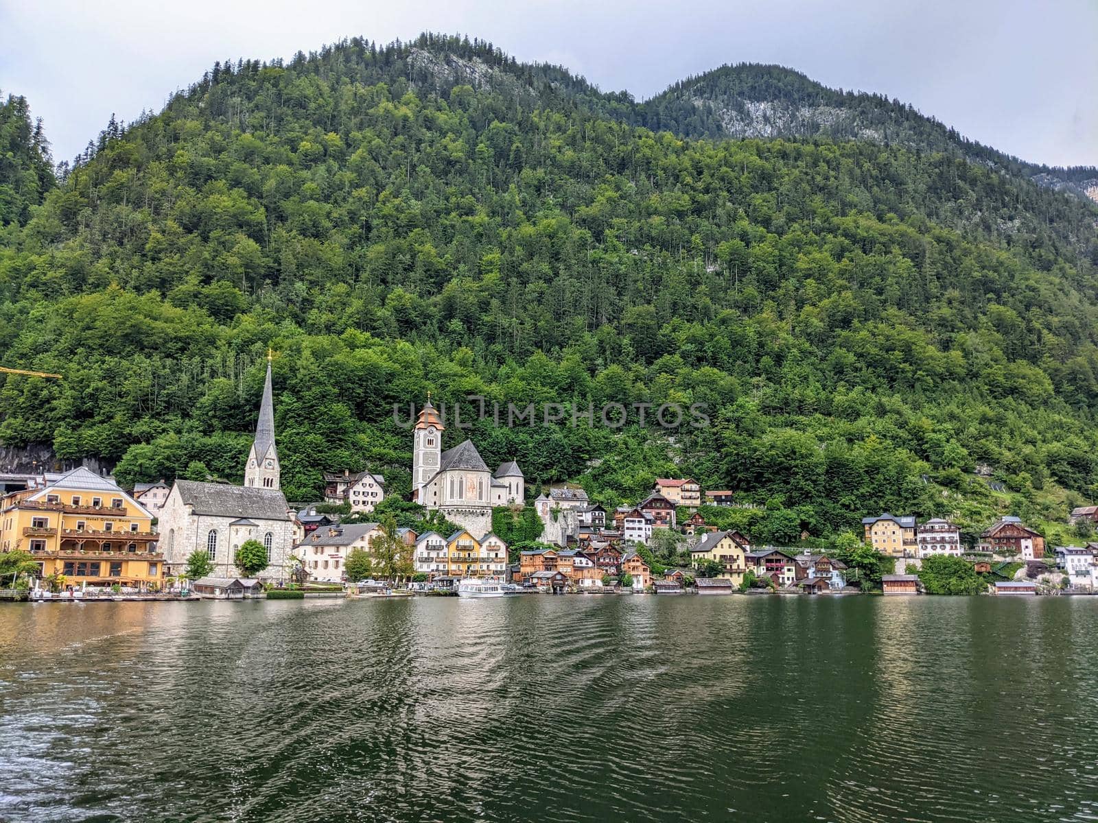 Hallstatt Austria city at lake and mountains panorama with church from the lake