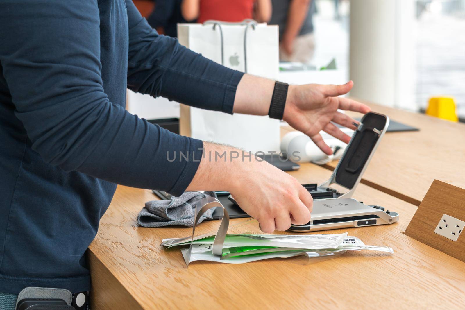 Aventura, Florida, USA - September 20, 2019: Closeup view of applying screen protector on an iPhone 11 pro in Apple store in Aventura mall
