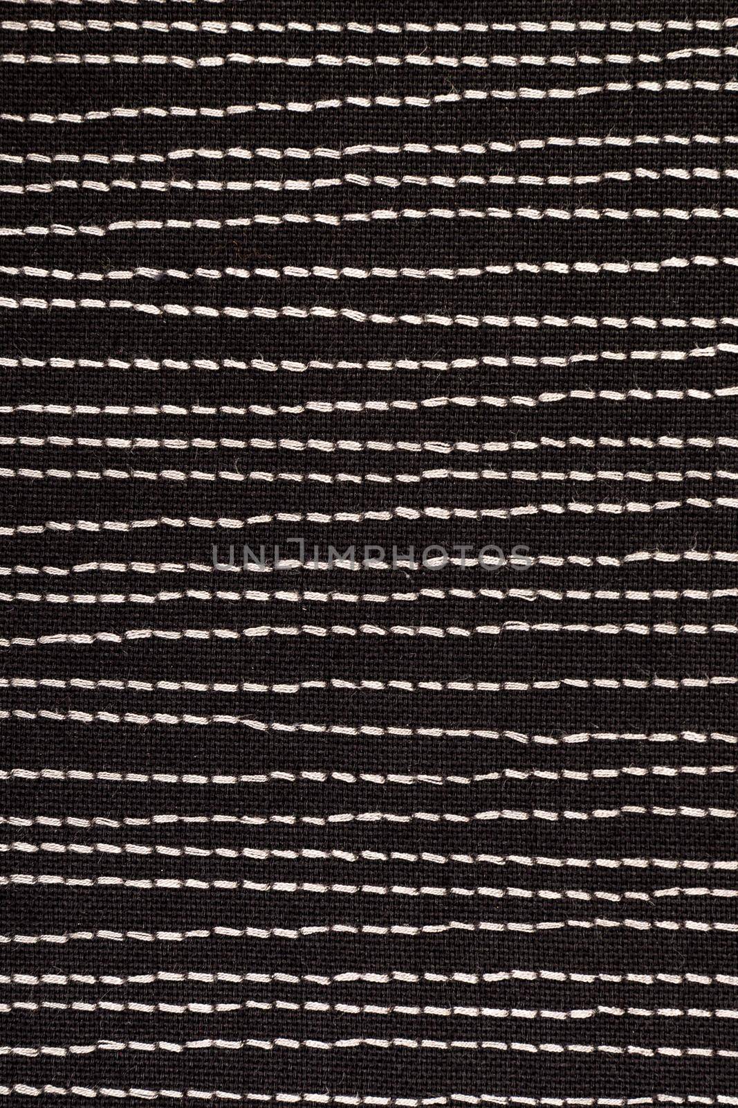 Black fabrick with white stitches background texture