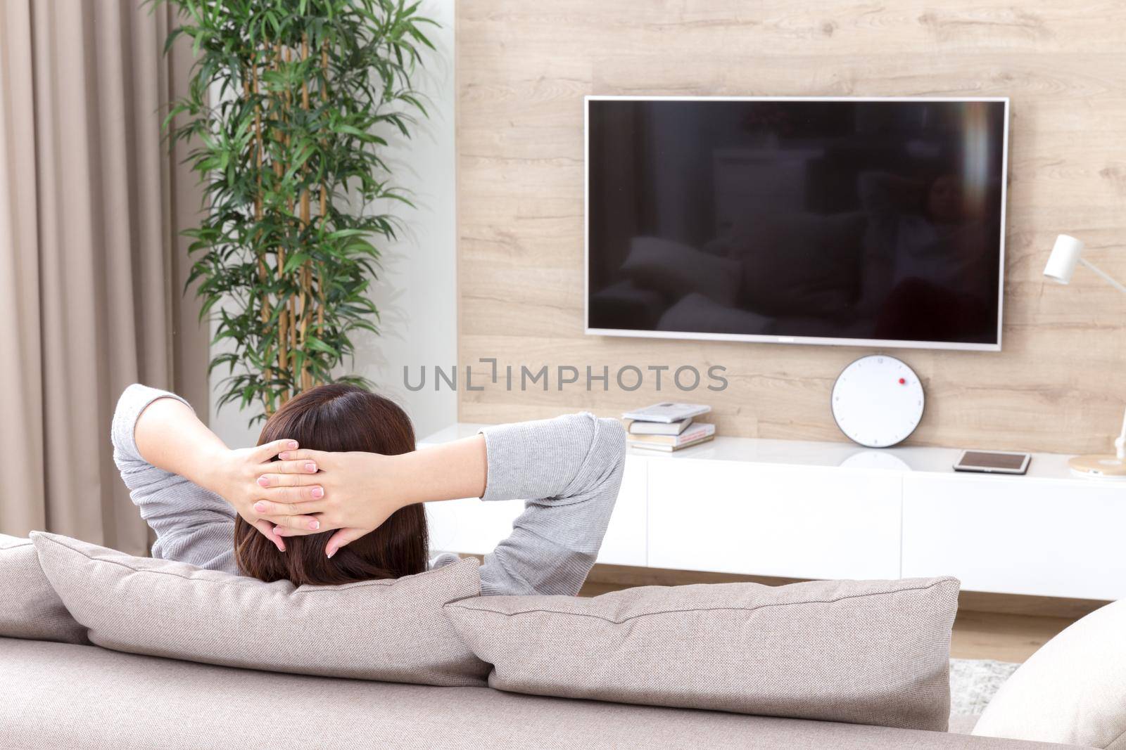 Young woman watching TV in the living room
