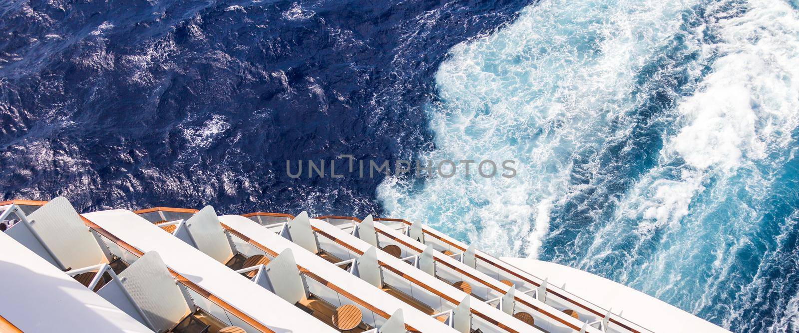 Balconies on a backof Cruise ship, decks with wake or trail on ocean surface