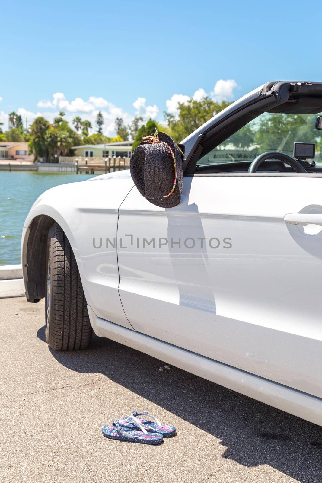 Convertible car with hat hanging on mirror