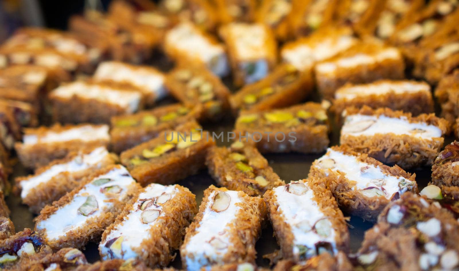 Turkish traditional dessert Kadayif  baked in syrup served with nut powder